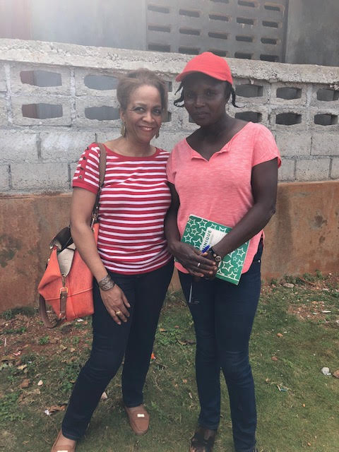 Two women smile for the camera.